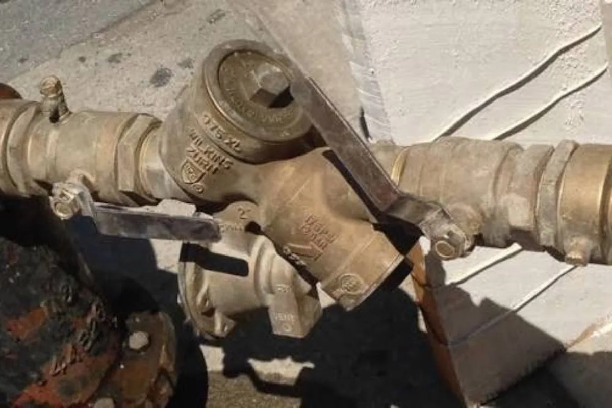 Backflow prevention assembly being tested with a gauge kit