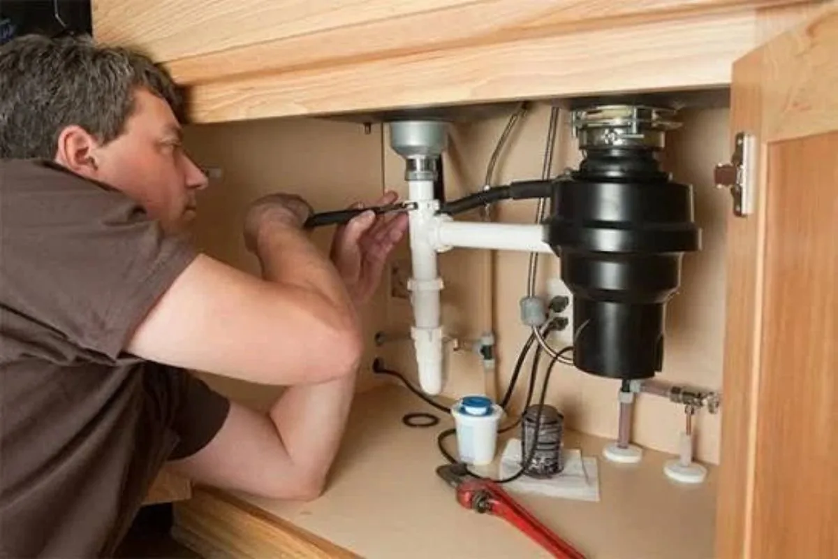 Garbage disposal unit mounted under a kitchen sink