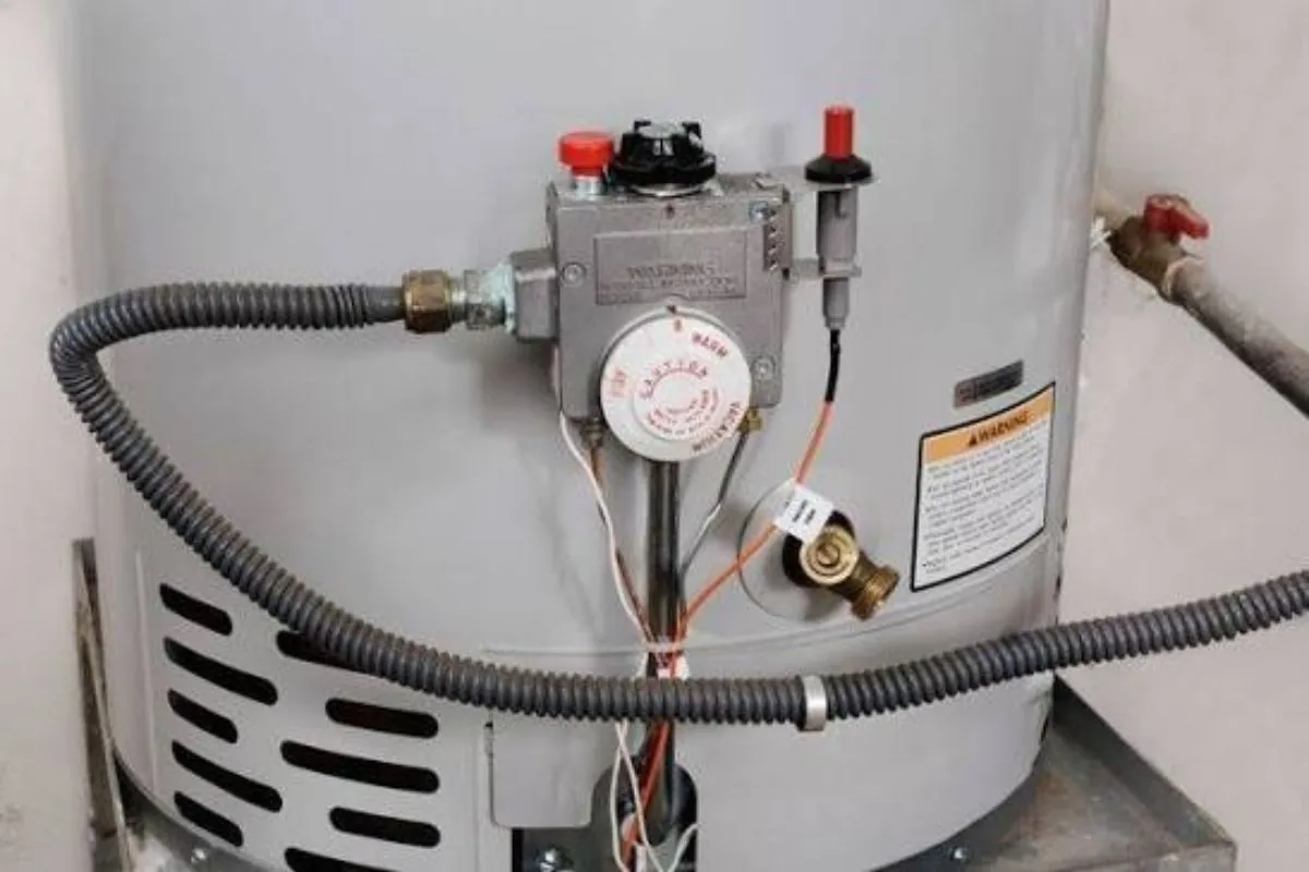 New water heater installed beside a removed old unit in a Florida garage